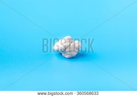 Chewed Chewing Gum On A Blue Background. Bad Gum. Close Up. Macro Mode.