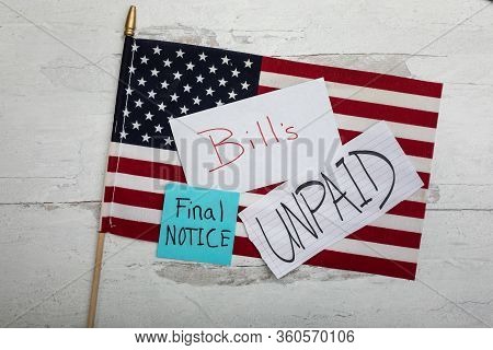 Signs With The Word And Prases Bill's Unpaid And Final Notice Laying On An American Flag Flat Lay Ba