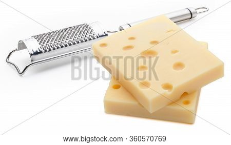 Two Portions (blocks) Of Emmental Swiss Cheese With A Grater. Texture Of Holes And Alveoli. Isolated
