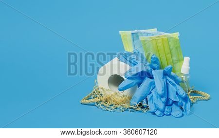 End Of Coronavirus Quarantine. A Female Hand Throws Used Face Masks Into A Trash Can. Return To Norm