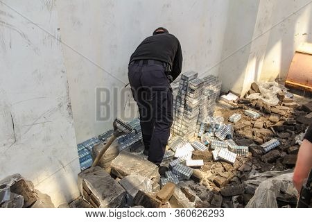Krakovets, Ukraine - May, 2019: The Border Guard In Special Uniforms Throws Smuggled Cigarettes, Whi