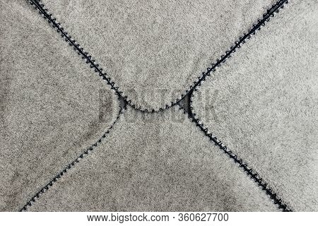 Gray Spathe Folded In An Envelope With Blue Threading Edges. Close-up Of Natural Warm Wool Coverlet,