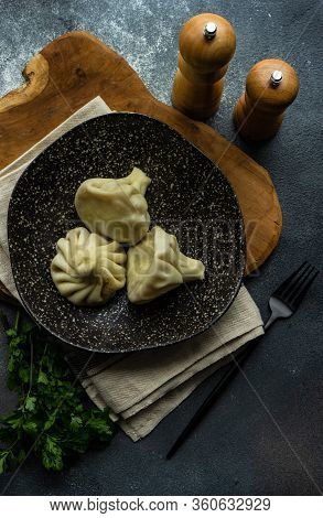 Traditional Georgian Khinkali Dish On Stone Background
