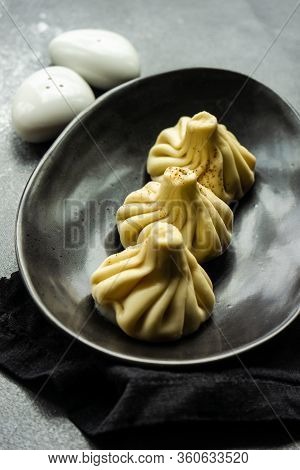 Traditional Georgian Khinkali Dish On Stone Background