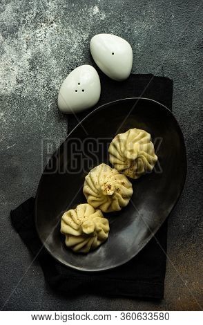Traditional Georgian Khinkali Dish On Stone Background