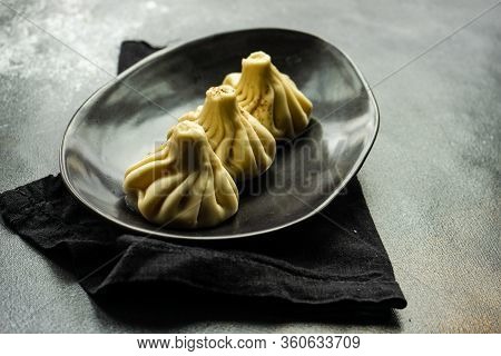 Traditional Georgian Khinkali Dish On Stone Background