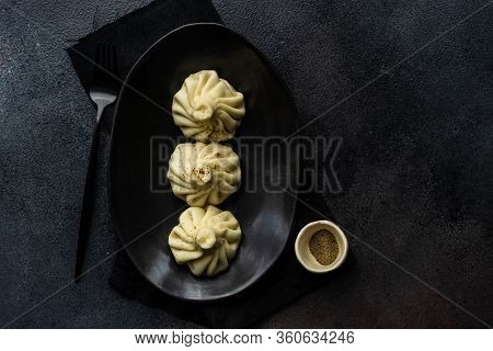 Traditional Georgian Khinkali Dish On Stone Background