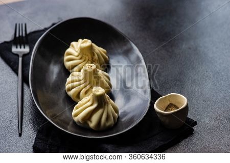 Traditional Georgian Khinkali Dish On Stone Background