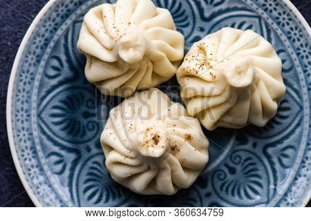 Traditional Georgian Khinkali Dish On Stone Background