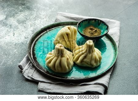 Traditional Georgian Khinkali Dish On Stone Background