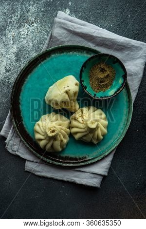 Traditional Georgian Khinkali Dish On Stone Background