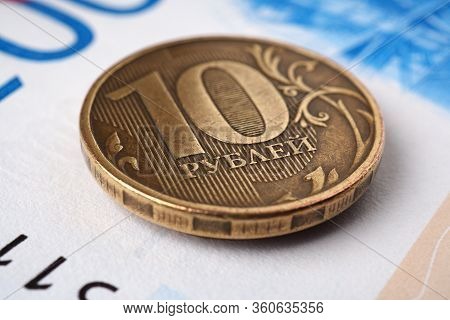 Coin 10 Rubles Close-up Lies On A Bill Of 2000 Rubles. Russian Money. Banks, Deposits, Loans. Microc