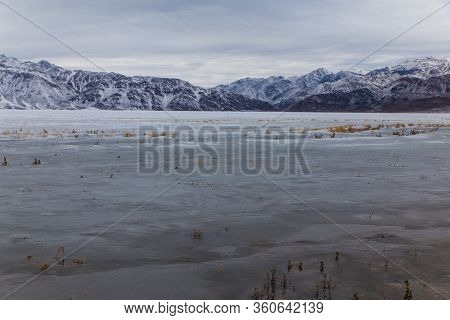 Bartogai Lake With Transparent Water With Mountains In Background In Winter Time Near Almaty, Kazakh