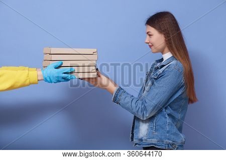 Profile Of Young Good Looking Lady Getting Carton Boxes With Food From Delivery Man In Gloves, Being