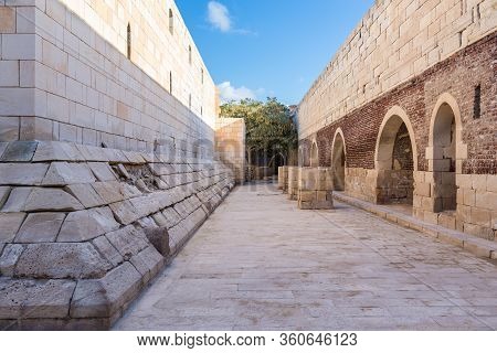 Exterior Of Ancient Passage With Shabby Red Bricks Passage And Crumbling Arched Alcoves On Street