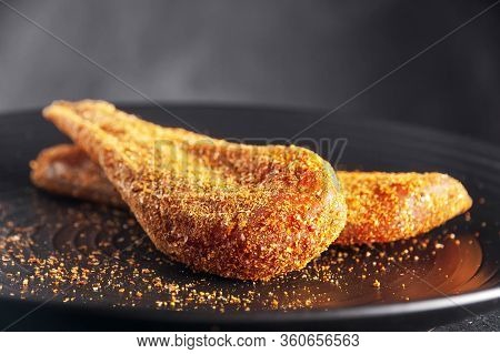 Seasoned Chicken With Hot Sauce And A Sprig Of Rosemary