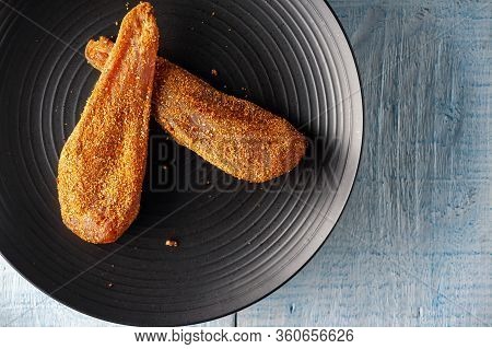 Seasoned Chicken With Hot Sauce And A Sprig Of Rosemary