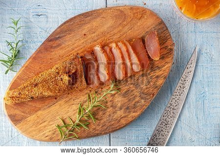 Seasoned Chicken With Hot Sauce And A Sprig Of Rosemary