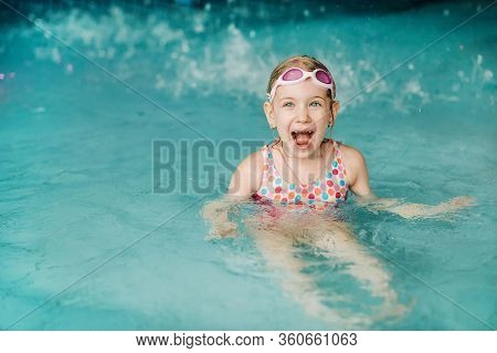 Kids Play In Aqua Park. Children At Water Playground Of Tropical Amusement Park. Little Girl At Swim