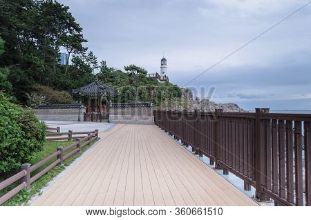 Dongbaek Lighthouse View From Below Part Of Naru Park On Gloomy Day