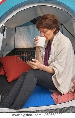 Quarantine At Home. Woman Sit Inside A Tent Enjoying A Cup Of Tea