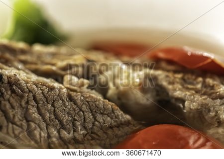 Shorpo In A White Plate With A Piece Of Beef Meat In A Broth With Vegetables Close Up