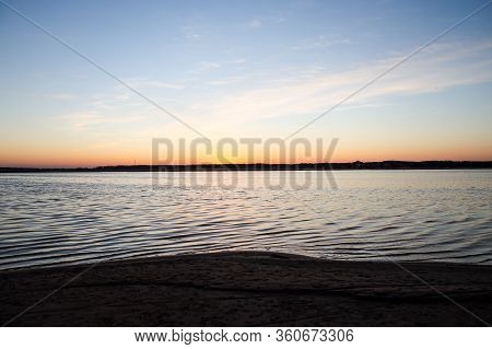 Beautiful Landscape View With River Slowly Flowing With Small Waves During The Sunset. Photo Taken I