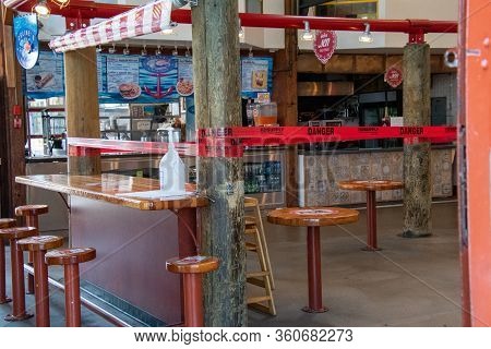 Tables Inside The Granville Island Public Marketplace Taped Off And Off Limit During The Covid-19 Pa