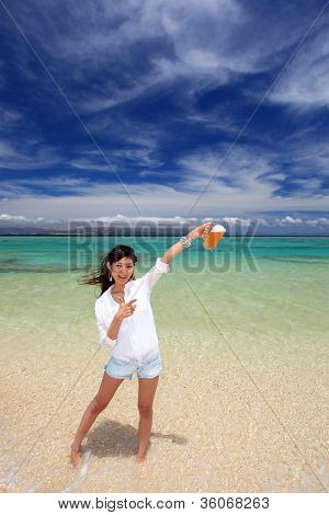 ผู้หญิงที่ดื่มเบียร์ริมชายหาด