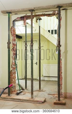 Removing, Knocking Down A Wall, With The Brickwork Supported By Acrow Props During A Uk House Interi