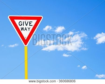 Give Way Sign On Blue Sky Background (with Clipping Path)