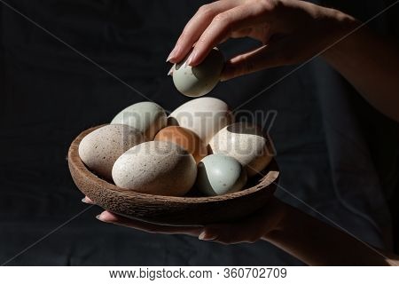 Araucana Eggs And Goose Eggs On A Wooden Plate