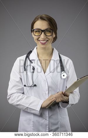 Beautiful Smart Sexy Female Doctor In White Medical Coat And Stethoscope Holding Clipboard And Frien
