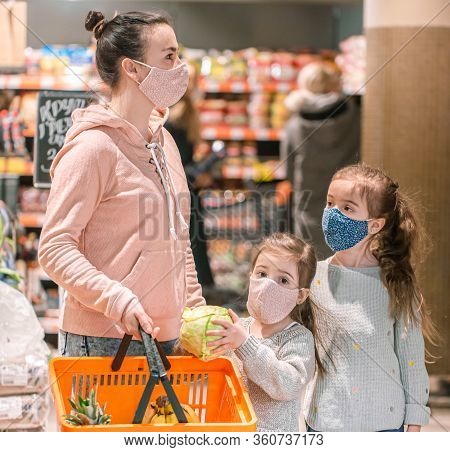 Mom And Kids Are Shopping At The Grocery Store.