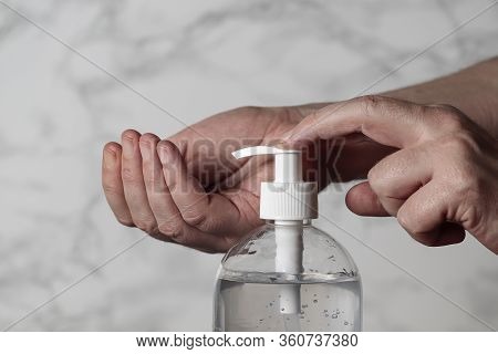 Horizontal View Hands In Foreground Using A Recommended Hygiene Gel To Prevent Any Posibility Of A C