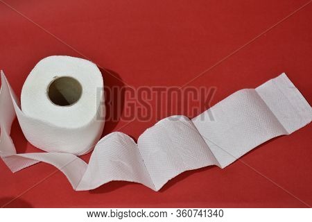Roll Of Toilet Paper On Red Background