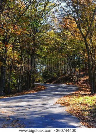 Curving Road Ascends Into The Ozarks Mountains On An Autumn Day.  Speed Limit Sign Reads 25mph.