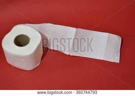 Roll Of Toilet Paper On Red Background