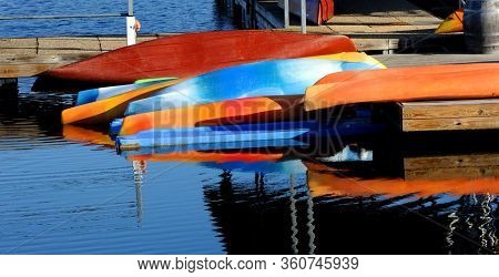 Vivid And Colorful Canoes Lay Upside Down At The Marina At Table Rock State Park In Branson, Missour
