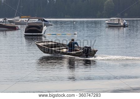 Grand Teton National Park, Wyoming / Usa - July 17, 2014:  A Man In A Small Boat Leaving Colter Bay 