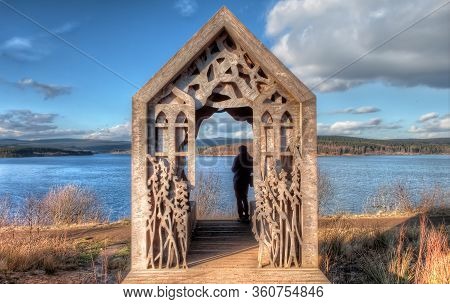 Timber Cabin Hut With Carvings Near A Lake At Kielder Water & Forest Park, Uk