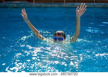 Child Drowning In To The Water And Show Up Hands For Help