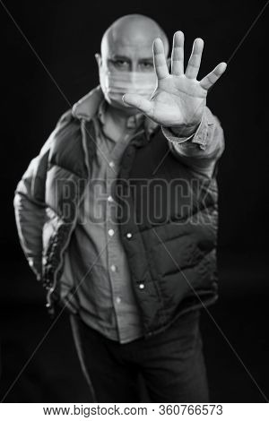 A Bald Adult Man In A Medical Mask Stands With His Hand Forward In Protest. Precautions Quarantined 
