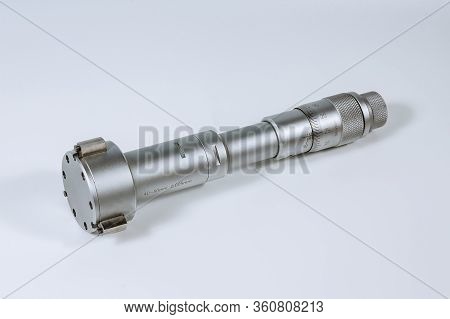 Calibration Micrometer. Device For Accurately Measuring The Diameter Of The Hole, On A White Backgro