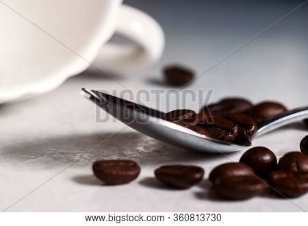 Coffee Beans And A White Cup On The Kitchen Table