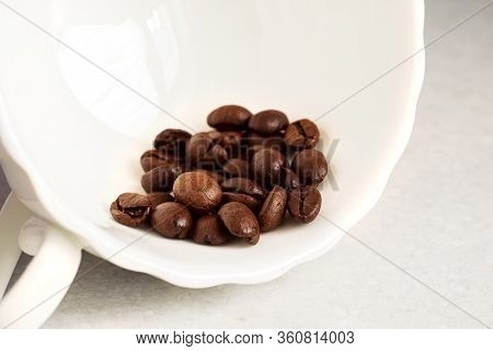 Coffee Beans And A White Cup On The Kitchen Table