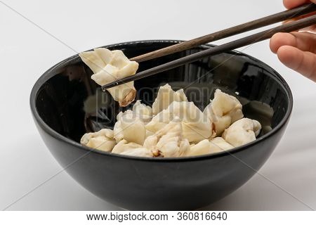 Hand Picking Jumbo Lump Of Fresh Crab Meat Among The Others With Chopsticks In The Black Ceramic Bow