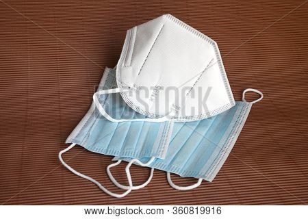 White Kn95 Or N95 Mask With Antiviral Medical Mask For Protection Against Coronavirus On Brown Backg