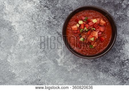 A Bowl Of Tomato Gazpacho Soup. Copy Space. Stone Gray Background. Top View Of Gazpacho Soup. Gazpac