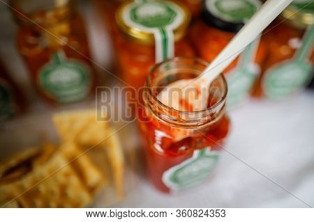 Shallow Depth Of Field (selective Focus) Image With Plastic Spoon In A Glass Jar Filled With A Red S